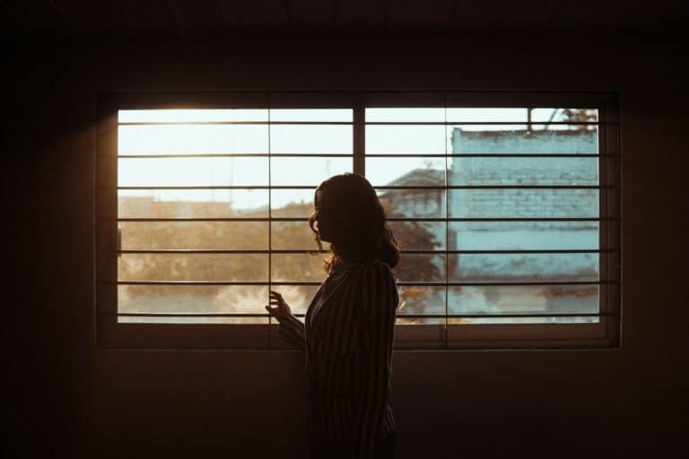 A woman looking through the window.